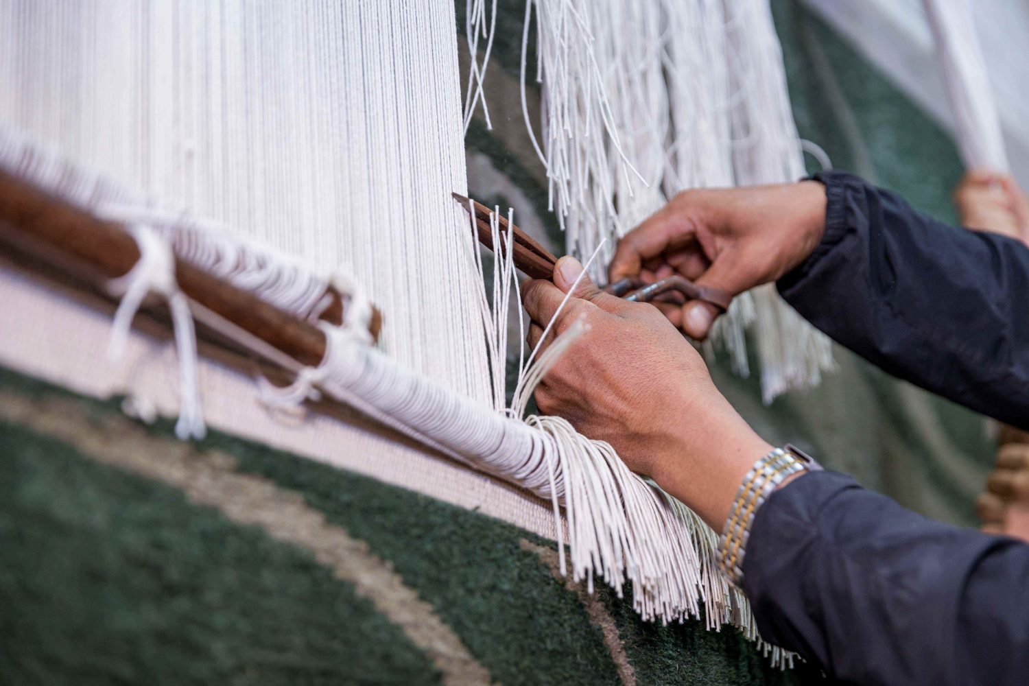 A Hand Knotted Rug Being Cut Off The Loom in Our Factory in Nepal, Photographed by Anup Paudel